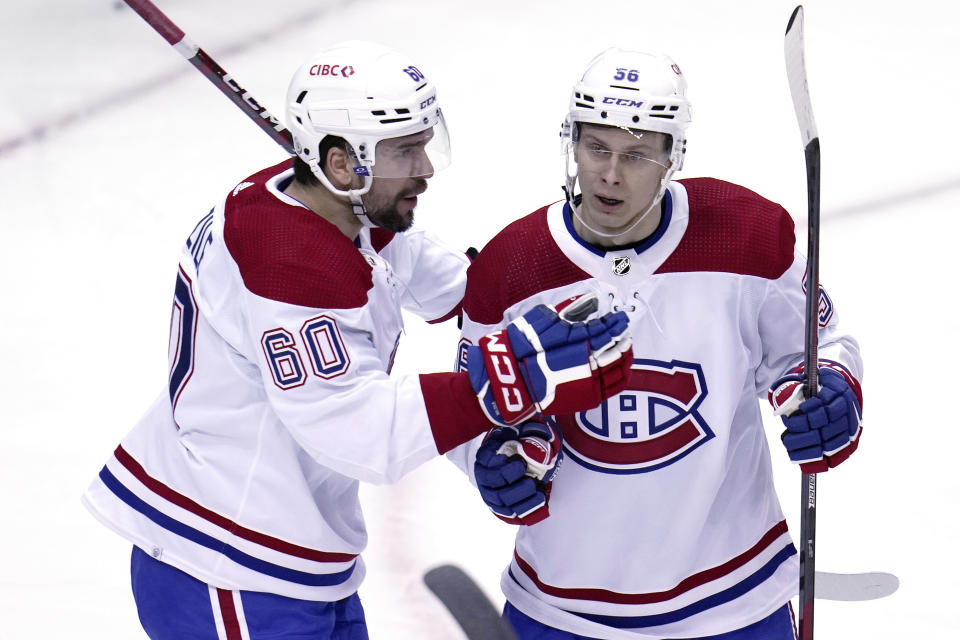 Montreal Canadiens' Jesse Ylonen (56) celebrates his goal against the Pittsburgh Penguins with Alex Belzile during the first period of an NHL hockey game in Pittsburgh, Tuesday, March 14, 2023. (AP Photo/Gene J. Puskar)