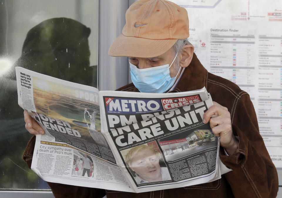 A man reads a newspaper with the headline: 'PM in intensive care', outside St Thomas' Hospital in central London as British Prime Minister Boris Johnson is in intensive care fighting the coronavirus in London, Tuesday, April 7, 2020. Johnson was admitted to St Thomas' hospital in central London on Sunday after his coronavirus symptoms persisted for 10 days. Having been in hospital for tests and observation, his doctors advised that he be admitted to intensive care on Monday evening. The new coronavirus causes mild or moderate symptoms for most people, but for some, especially older adults and people with existing health problems, it can cause more severe illness or death.(AP Photo/Kirsty Wigglesworth)