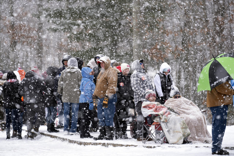 People wait to enter a Republican presidential candidate former President Donald Trump campaign event during a winter snowstorm in Atkinson, N.H., Tuesday, Jan. 16, 2024. (AP Photo/Matt Rourke)