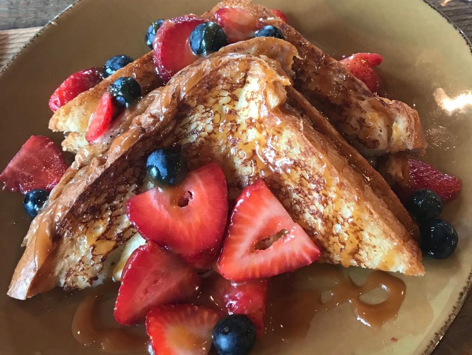 plate of french toast with fresh fruit from wine bar george in disney springs