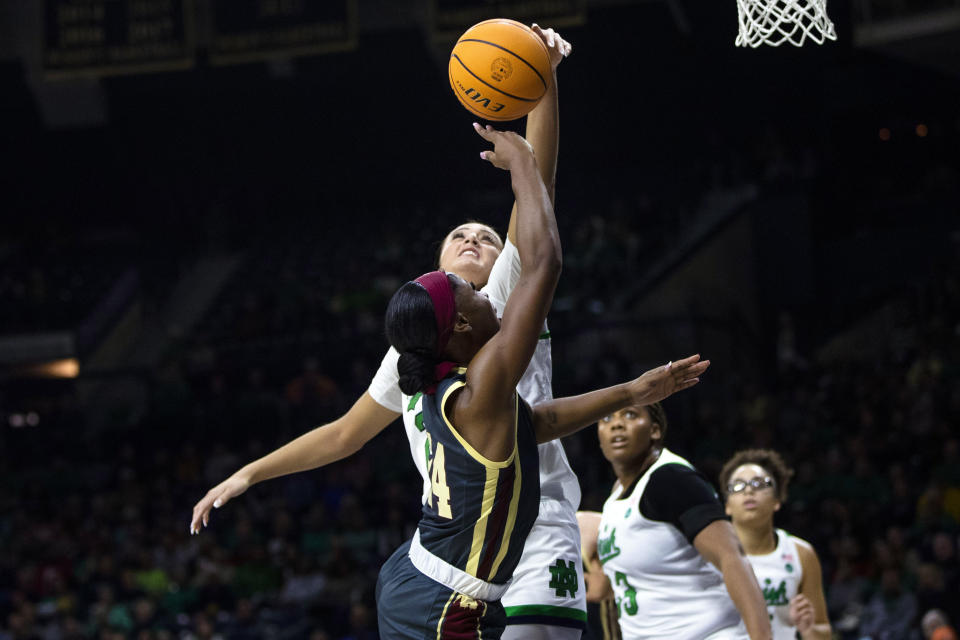 Boston College's Dontavia Waggoner (24) has her shot blocked by Notre Dame's Kylee Watson (22) during the second half of an NCAA college basketball game Sunday, Jan. 1, 2023 in South Bend, Ind. (AP Photo/Michael Caterina)