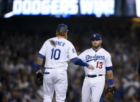 Aug 31, 2018; Los Angeles, CA, USA; Los Angeles Dodgers first baseman Max Muncy (13) celebrates with third baseman Justin Turner (10) after defeating the Arizona Diamondbacks 3-2 at Dodger Stadium. Mandatory Credit: Kelvin Kuo-USA TODAY Sports