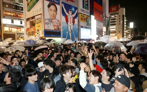 People celebrate as new Emperor Naruhito's era of Reiwa, or "beautiful harmony" began early Wednesday, May 1 - Credit: &nbsp;Kyodo News/AP