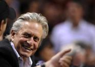 Michael Douglas laughs from the sidelines during the second half as the Miami Heat and the Oklahoma City Thunder play in Miami, April 4 2012.