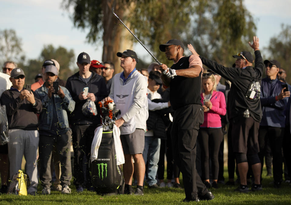 Tiger Woods hits out of the rough on the 18th hole during the first round of the Genesis Invitational golf tournament at Riviera Country Club, Thursday, Feb. 13, 2020, in the Pacific Palisades area of Los Angeles. (AP Photo/Ryan Kang)