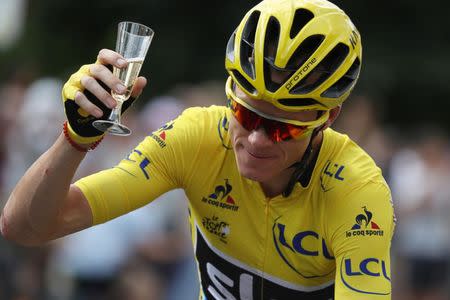 FILE PHOTO: Cycling - Tour de France cycling race - The 113-km (70,4 miles) Stage 21 from Chantilly to Paris, France, July 24, 2017. Yellow jersey leader Team Sky rider Chris Froome of Britain holds a glass of champagne after the start. REUTERS/Kenzo Tribouillard/Pool/File Photo