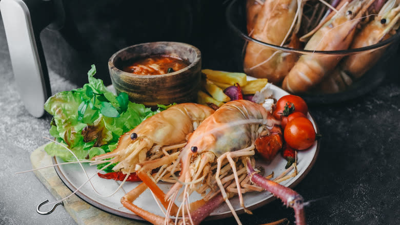 uncooked shrimp next to air fryer