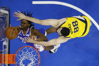 Philadelphia 76ers' Tyrese Maxey, left, goes up for a shot against Indiana Pacers' Goga Bitadze during the first half of an NBA basketball game, Monday, March 1, 2021, in Philadelphia. (AP Photo/Matt Slocum)