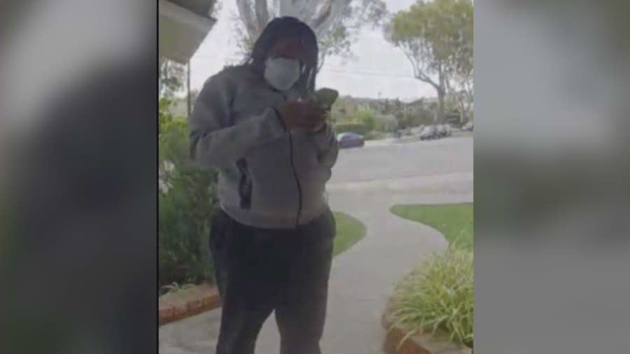 Security footage shows the woman with a mask waiting at the victim’s front door after ringing the doorbell. The victim shared these images with KTLA on April 29, 2024. (Harry Whelan)