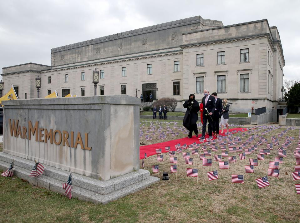 New Jersey Gov. Phil Murphy and his family join Lt. Gov. Shelia Oliver in placing white roses outside the Trenton War Memorial Tuesday, January 18, 2022, to remember those lost to COVID.