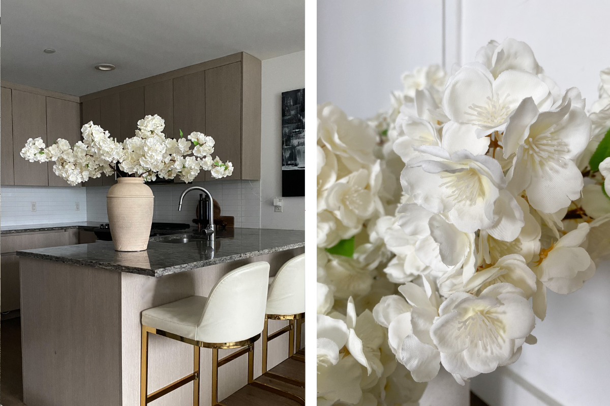 a vase of white flowers on a kitchen counter