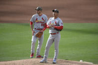 St. Louis Cardinals starting pitcher Kwang Hyun Kim (33) stands on the mound next to third baseman Nolan Arenado (28) before leaving the game in the fourth inning of a baseball game against the San Diego Padres Sunday, May 16, 2021, in San Diego. (AP Photo/Denis Poroy)