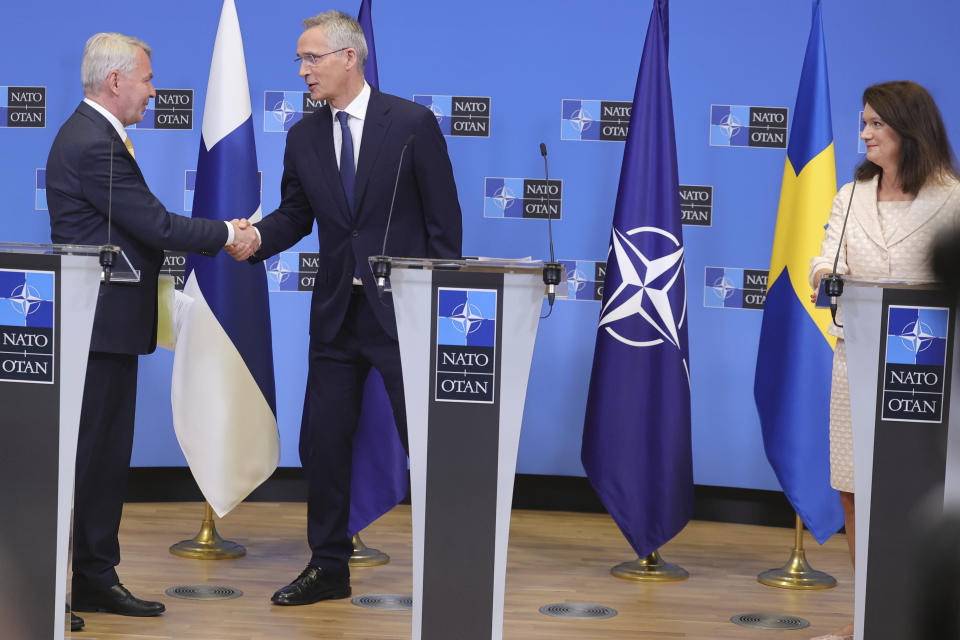 Finland's Foreign Minister Pekka Haavisto, left, Sweden's Foreign Minister Ann Linde, right, and NATO Secretary General Jens Stoltenberg attend a media conference after the signature of the NATO Accession Protocols for Finland and Sweden in the NATO headquarters in Brussels, Tuesday, July 5, 2022. (AP Photo/Olivier Matthys)