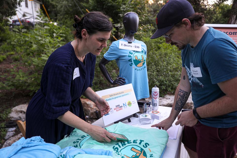 Kam McEvoy, left, speaks to Michael Kaurich at the launch party for Safe Streets Austin, a nonprofit focused on making the city more pedestrian- and cyclist-friendly. McEvoy, an administrative assistant for the organization, sold shirts and stickers and signed up visitors for memberships. Residents and city leaders met at the Tudor House at Pease Park on May 12.