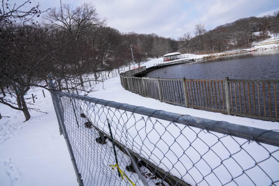 The boardwalk at Greenwood Pond: Double Site sits fenced off to visitors Friday, Feb. 16, 2024, at Greenwood Park. The longstanding art installation is being removed later this year due to safety and cost concerns.