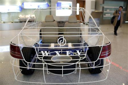 A structure model of an electric automobile is displayed inside an exhibition room of Wanxiang electric car factory in Hangzhou, Zhejiang province, January 22, 2014. REUTERS/Aly Song