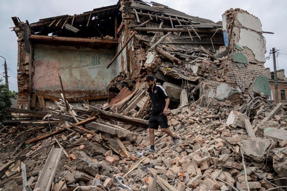 A man walked along a destroyed house in Ukraine