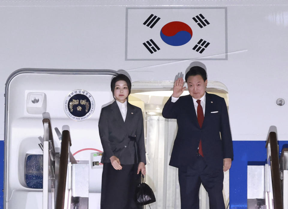 South Korean President Yoon Suk Yeol waves next to his wife Kim Keon Hee, before departing for the United States to attend the NATO Summit, at the Seoul military airport in Seongnam, South Korea, Monday, July 8, 2024. (Hong Hae-in/Yonhap via AP)