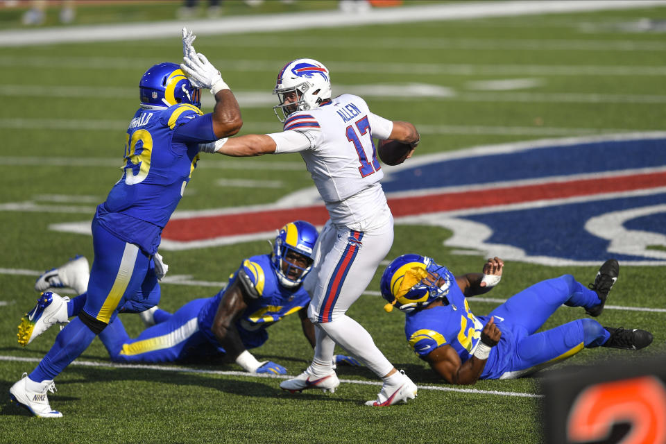 Los Angeles Rams' Aaron Donald, left, rushes Buffalo Bills quarterback Josh Allen during the second half of an NFL football game Sunday, Aug. 26, 2018, in Orchard Park, N.Y. Allen was called for a face mask penalty on the play. The Bills won 35-32. (AP Photo/Adrian Kraus)