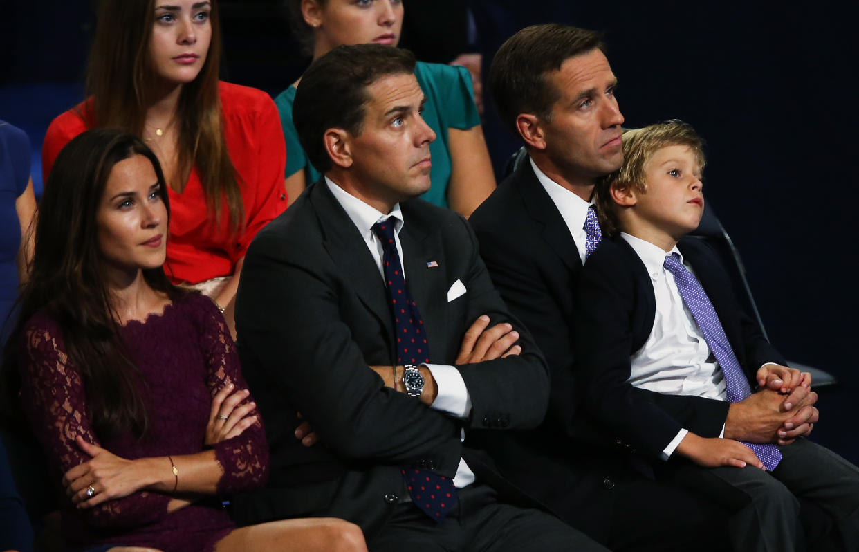Ashley, Hunter and Beau Biden look onstage while seated among other people