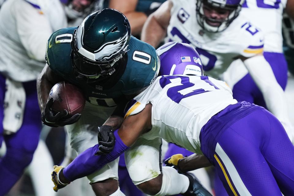 Philadelphia Eagles running back D'Andre Swift (0) is stopped by Minnesota Vikings cornerback Akayleb Evans (21) during the second half of an NFL football game Thursday, Sept. 14, 2023, in Philadelphia. (AP Photo/Matt Rourke)