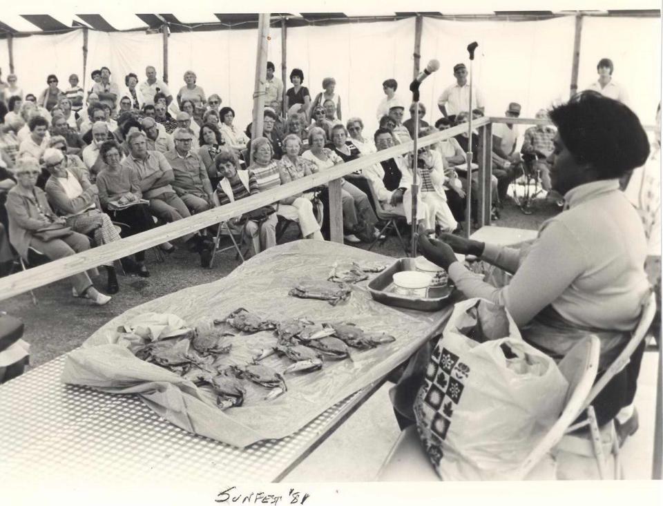 A crowd gathers at Sunfest to watch a crab-picking demonstration in 1981 in Ocean City, Md.