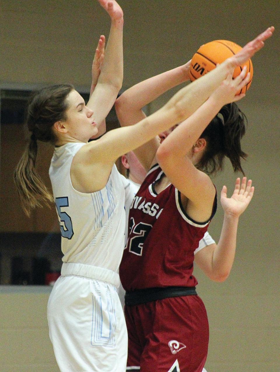 Bartlesville High forward Ragen Hodge, left, pressures the shot of an Owasso Lady Rams' player during varsity girls basketball action earlier in her career.