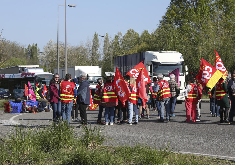 Demonstrators block the access to the Ikea store in protest against the pension reforms in Bayonne, southwestern France, Thursday, April 20, 2023. Union activists stage scattered actions to press France's government to scrap the new law raising the retirement age. (AP Photo/Bob Edme)