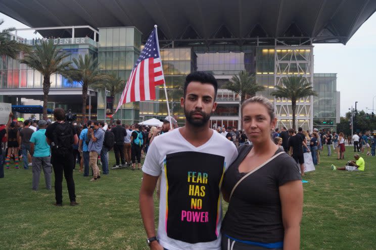 Rafael Martins, left, and Christiani Pitts attend a vigil outside the Dr. Phillips Center for the Performing Arts in downtown Orlando on Monday. (Photo: Michael Walsh/Yahoo News)