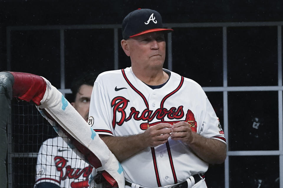 Atlanta Braves manager Brian Snitker (43) watches from the dugout during the team's baseball game against the Colorado Rockies on Wednesday, Sept. 15, 2021, in Atlanta. (AP Photo/John Bazemore)