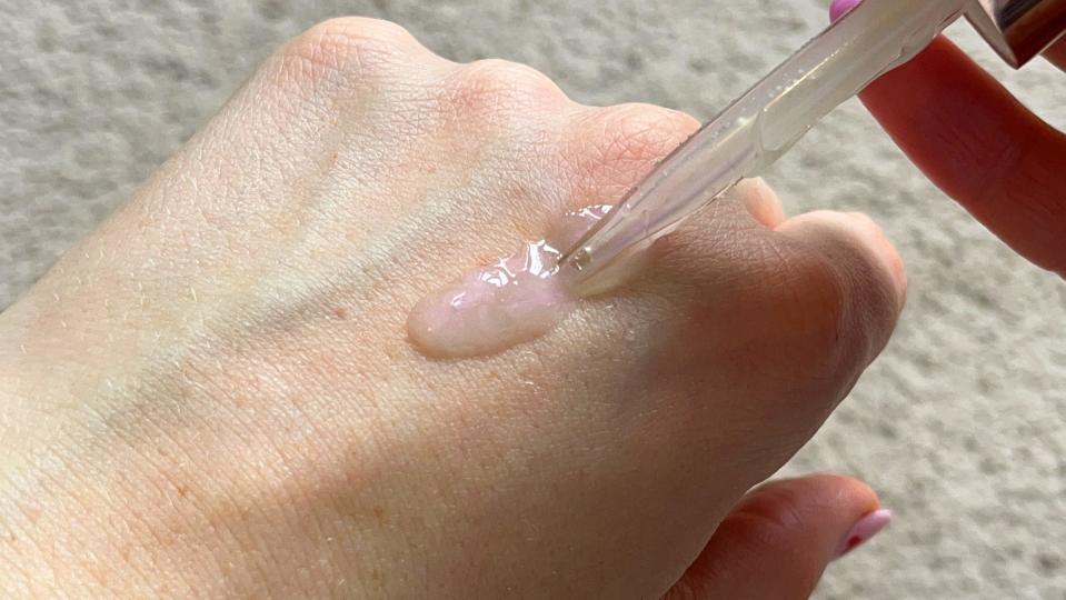 It has a pearly, iridescent shimmer when you first apply it, but it doesn't linger on your skin. (Yahoo Life UK)