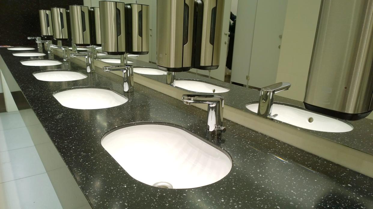 Pattern of modern bathroom sink and faucet in public toilet and restroom. Touchless taps. Virus protection concept. Sanitary rules and requirements. Contemporary washroom and wc in Office centre