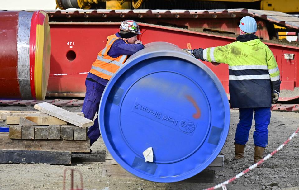 Men work at the construction site of the so-called Nord Stream 2 gas pipeline in Lubmin, northeastern Germany, in 2019. The Biden administration has put Russia on notice that the pipeline will not be allowed to operate if Russia invades Ukraine.