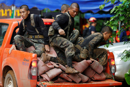 Soldiers alight from a vehicle as they work near the Tham Luang cave complex during a search for members of an under-16 soccer team and their coach, in the northern province of Chiang Rai, Thailand, June 27, 2018. REUTERS/Soe Zeya Tun