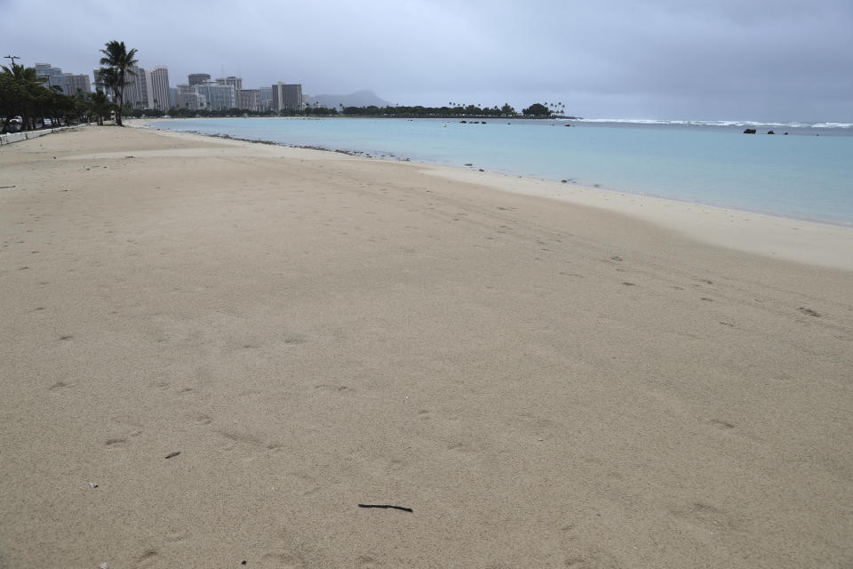 Ala Moana Beach Park was mostly empty of beachgoers, Monday, Dec. 6, 2021, in Honolulu, due to a strong storm packing high winds and extremely heavy rain. (AP Photo/Marco Garcia)