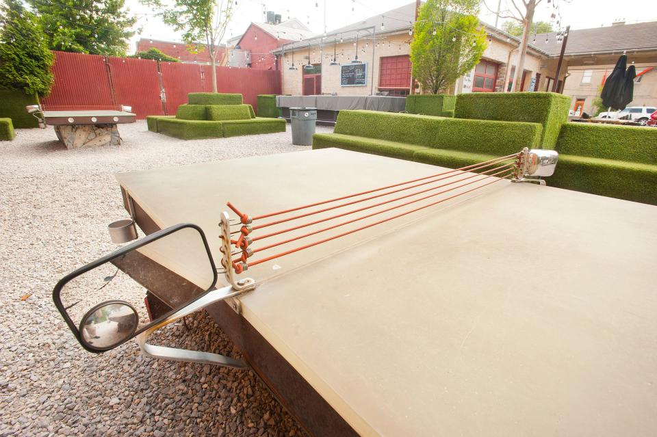 Vintage automotive items mix with eatery booths in the NuLu restaurant, Garage Bar, 700 E. Market Street. Outside the eatery, patrons may enjoy the ping-pong tables equipped with side-view mirrors.08 July 2019