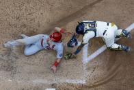 Milwaukee Brewers catcher Omar Narvaez tags out St. Louis Cardinals' Tommy Edman at home during the seventh inning of a baseball game Thursday, May 13, 2021, in Milwaukee. Edman tries to score from third on a fly ball hit by Paul Goldschmidt. (AP Photo/Morry Gash)