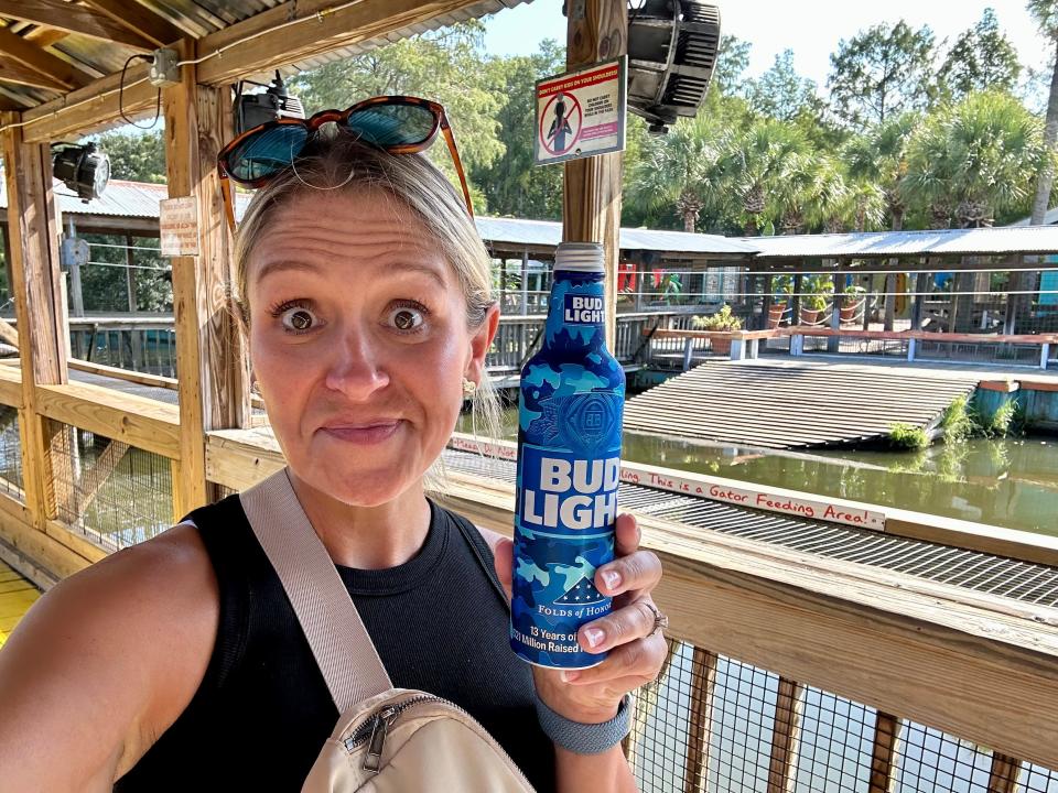 Author Terri Peters holding a bud light at gatorland