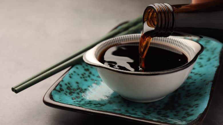 Soy sauce pouring into bowl