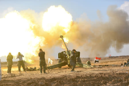 Members of Hashid Shaabi or Popular Mobilization Forces (PMF) fire towards Islamic State militant positions in west of Mosul, Iraq, December 28, 2016. REUTERS/Stringer