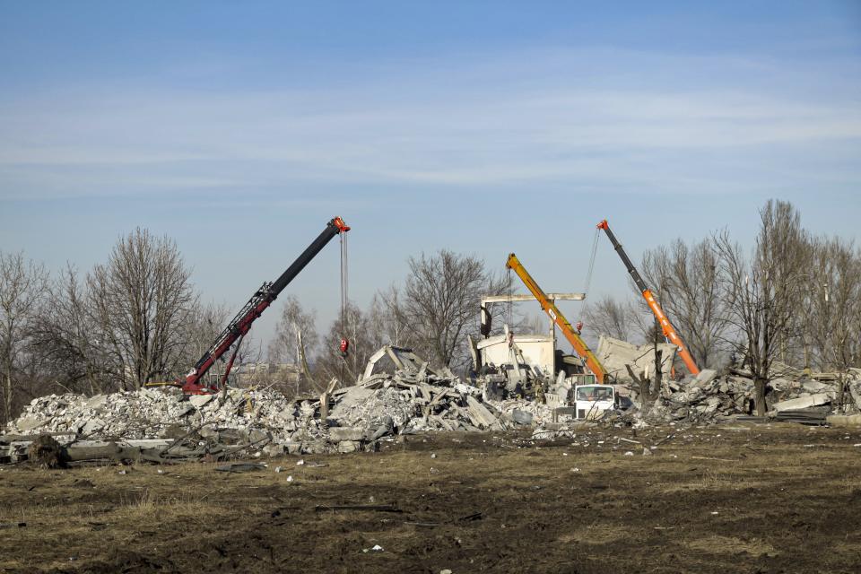 Workers clean rubbles after Ukrainian rocket strike in Makiivka, in Russian-controlled Donetsk region, eastern Ukraine, Tuesday, Jan. 3, 2023. Russia's defense ministry says 63 of its soldiers have been killed by a Ukrainian strike on a facility in the eastern Donetsk region where military personnel were stationed. (AP Photo)