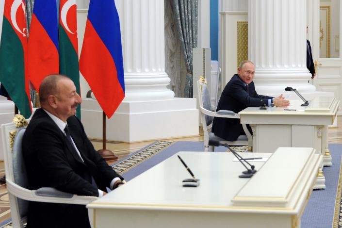 Russian President Vladimir Putin, right, looks at Azerbaijani President Ilham Aliyev during a joint news conference following their talks in the Kremlin in Moscow, Russia, Tuesday, Feb. 22, 2022. (Mikhail Klimentyev, Sputnik, Kremlin Pool Photo via AP)