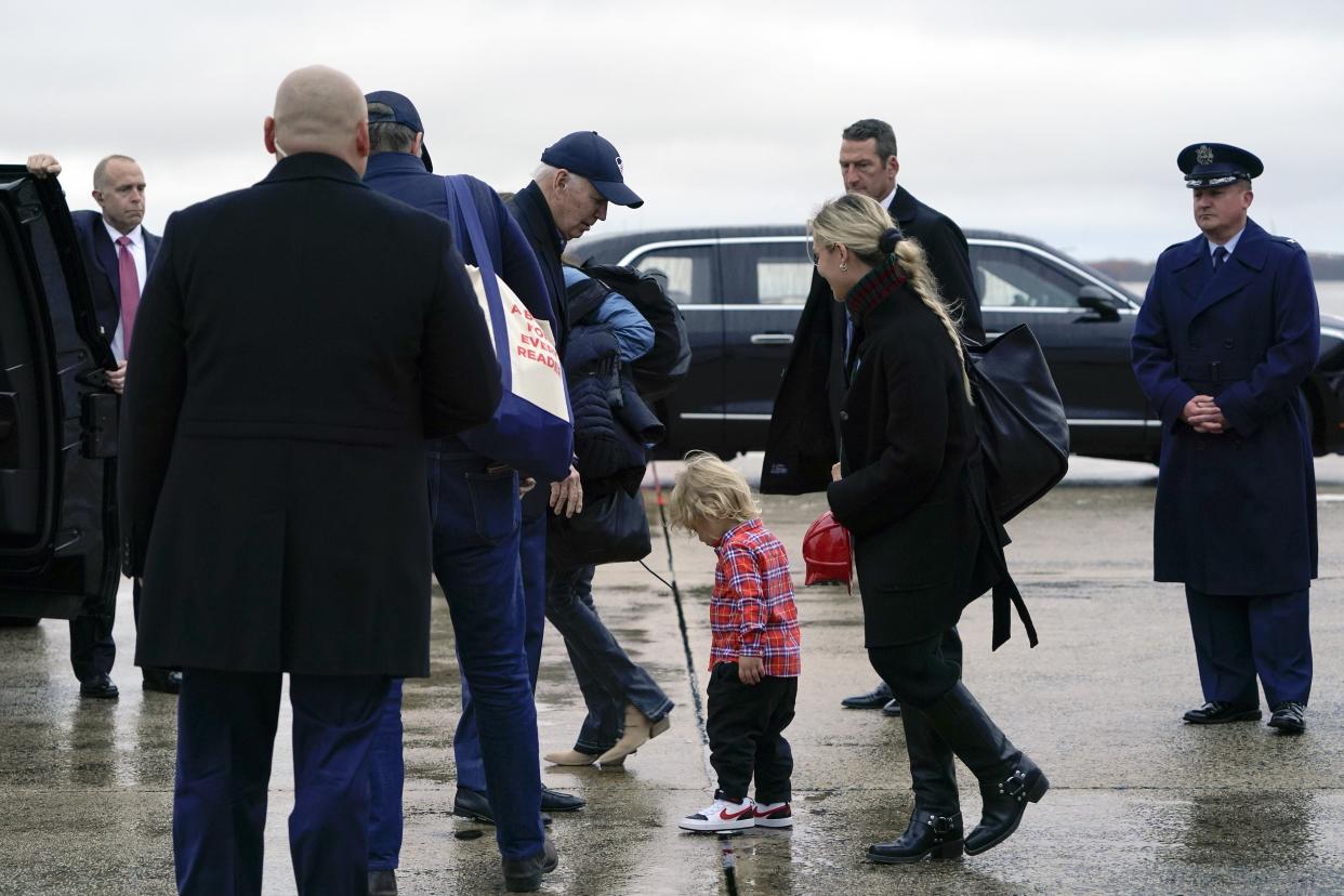 President Joe Biden looks at his grandson Beau Biden as they walk to their motorcade after arriving at Andrews Air Force Base, Maryland on Sunday, Nov. 27, 2022. The President is returning from Nantucket, Mass., where he spent the Thanksgiving Day holiday with family members. Hunter Biden and his wife Melissa Cohen look on.