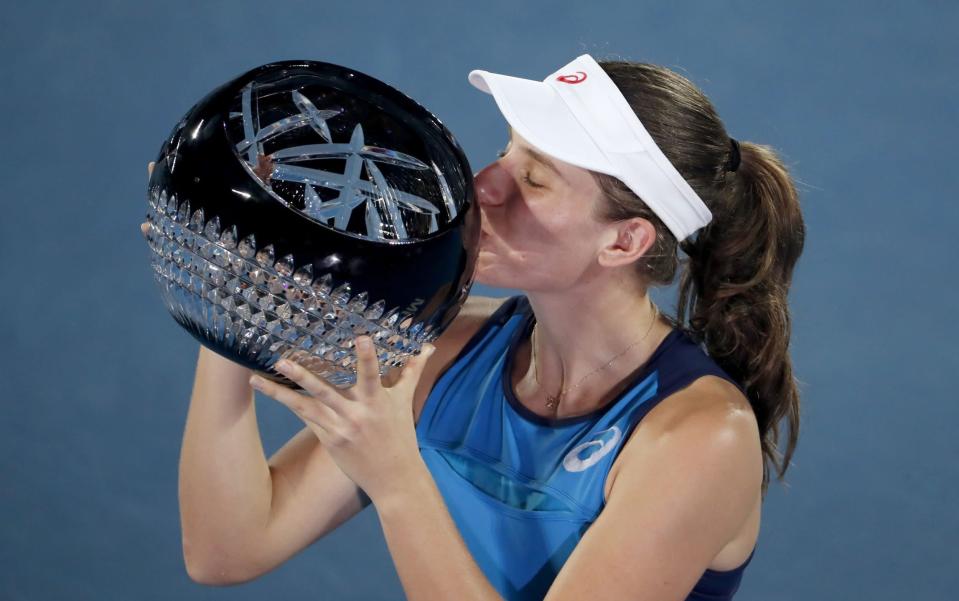 Johanna Konta of Britain kisses the trophy after beating Agnieszka Radwanska of Poland in the women&#39;s singles final match at the Sydney International tennis tournament in Sydney on January 13, 2017. - AFP