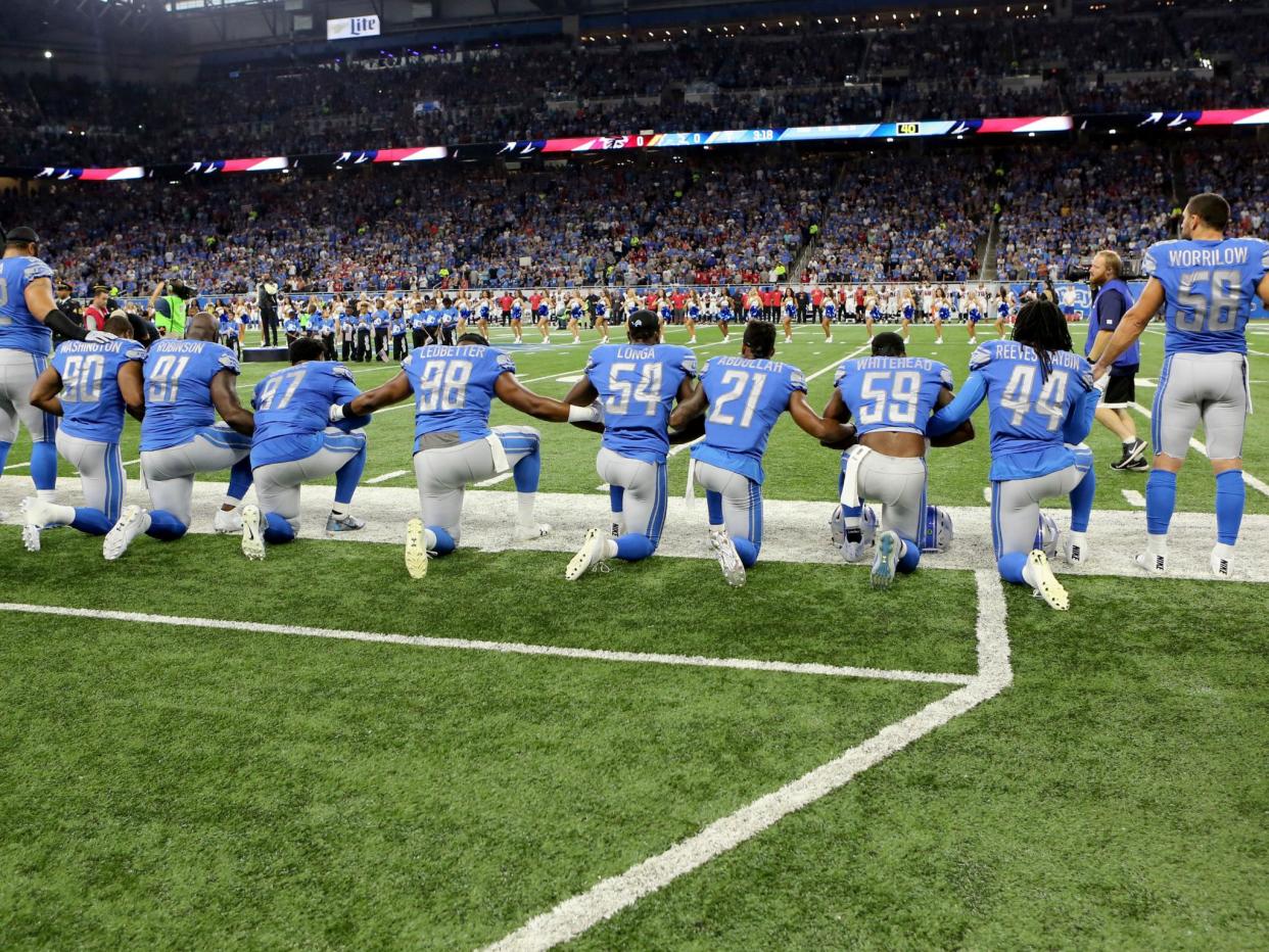 Members of the Detroit Lions take a knee during the playing of the national anthem prior to the start of the game against the Atlanta Falcons in Detroit, Michigan on 24 September: Rey Del Rio/Getty Images