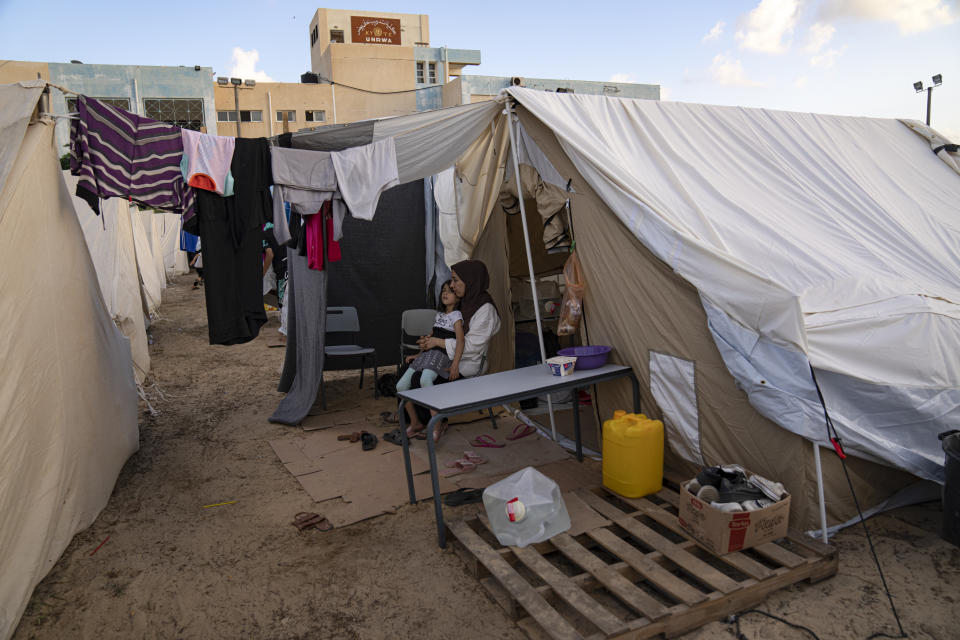 FILE - Palestinians displaced by the Israeli bombardment of the Gaza Strip sit in a UNDP-provided tent camp in Khan Younis on Thursday, Oct. 19, 2023. Hundreds of Palestinians have crowded into a squalid tent camp in southern Gaza, an image that has brought back memories of their greatest trauma. The impromptu construction of the tent city in Khan Younis to shelter scores of Palestinians who lost or fled their homes during the past days of intense Israeli bombardment has elicited anger, disbelief and sorrow across the Arab world. (AP Photo/Fatima Shbair, File)