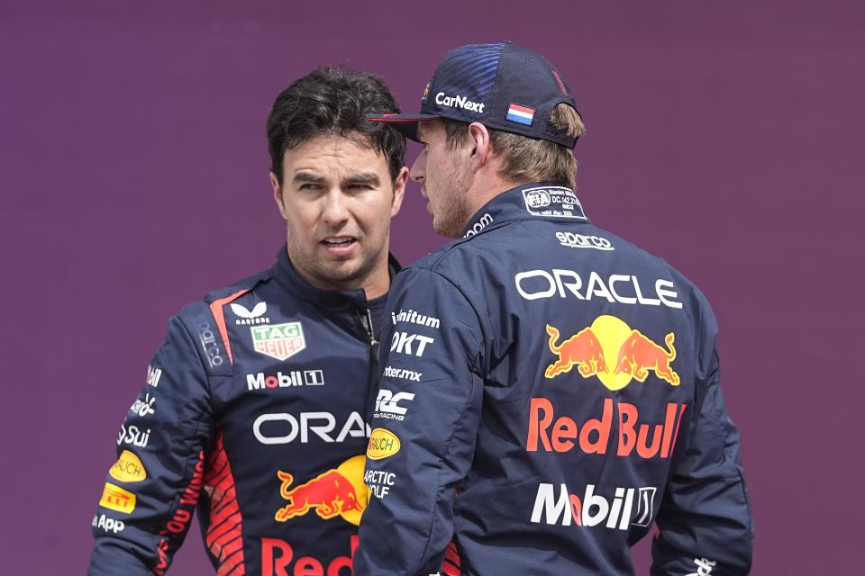 Red Bull driver Sergio Perez, left, of Mexico, talks with Red Bull driver Max Verstappen, of the Netherlands, following the sprint shootout ahead of the Formula One U.S. Grand Prix auto race at Circuit of the Americas, Saturday, Oct. 21, 2023, in Austin, Texas. Verstappen is on the pole for the sprint race. (AP Photo/Darron Cummings)