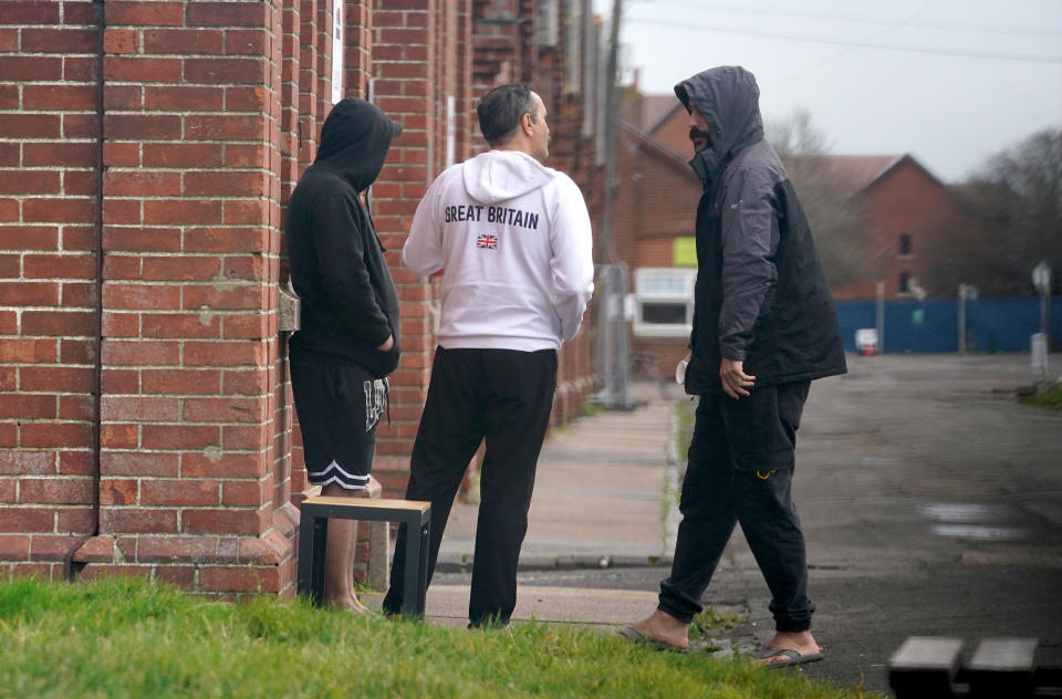 The government has been struggling to find places to home migrants while they wait for their applications. Those seen here are being housed at Napier Barracks in Folkestone. (PA)