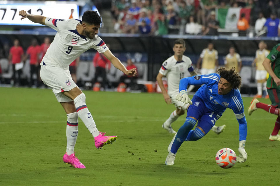 Ricardo Pepi of the United States kicks a goal past Goalkeeper Guillermo Ochoa of Mexico during the second half of a CONCACAF Nations League semifinals soccer match Thursday, June 15, 2023, in Las Vegas. (AP Photo/John Locher)