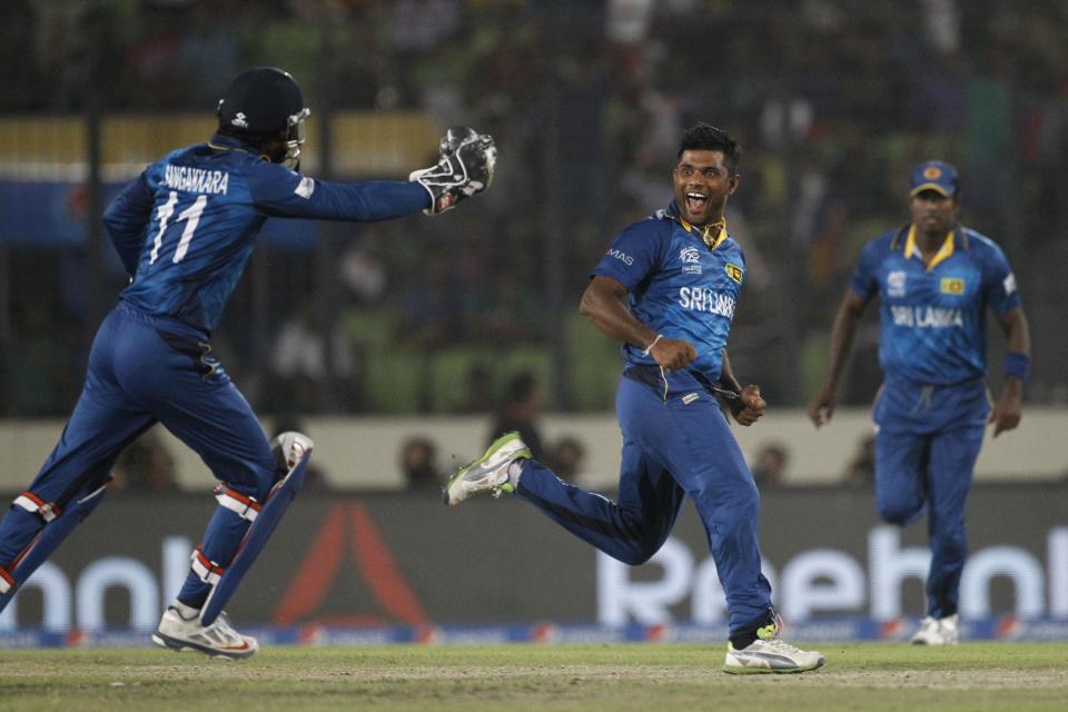 Sri Lanka's Seekkuge Prasanna, center, celebrates the wicket of West Indies' Lendl Simmons during their ICC Twenty20 Cricket World Cup semi-final match in Dhaka, Bangladesh, Thursday, April 3, 2014. cr(AP Photo/A.M. Ahad)
